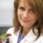Dr. Barbara Oglesbee with a parrot